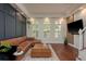 Stylish living room showcasing dark wood floors, a leather sectional, and panel accent wall at 2221 Soho Bay Ct, Tampa, FL 33606
