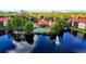 Stunning aerial view of a community waterfront pool with a fountain on the lake and red tiled roofs at 2400 Feather Sound Dr # 635, Clearwater, FL 33762