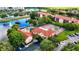 Aerial view of the community highlighting the pool, tennis courts, and the surrounding lush greenery at 2400 Feather Sound Dr # 635, Clearwater, FL 33762