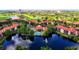 Aerial view of the neighborhood featuring lakes, tennis courts, pool, and red tile roofs at 2400 Feather Sound Dr # 635, Clearwater, FL 33762