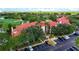 Aerial view of building with red tile roof, parking lot, landscaping, and golf course at 2400 Feather Sound Dr # 635, Clearwater, FL 33762