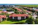 Aerial view of the neighborhood featuring lakes, tennis courts, and red tile roofs at 2400 Feather Sound Dr # 635, Clearwater, FL 33762