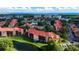 Aerial view of the neighborhood featuring lakes, tennis courts, and red tile roofs at 2400 Feather Sound Dr # 635, Clearwater, FL 33762