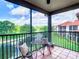 Relaxing balcony with seating and a view of the golf course, lake, and nearby buildings at 2400 Feather Sound Dr # 635, Clearwater, FL 33762