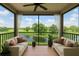 A serene balcony featuring comfortable seating with scenic golf course and lake views at 2400 Feather Sound Dr # 635, Clearwater, FL 33762