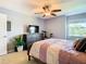 Bedroom view with TV, dresser, exercise bike, ceiling fan, and a beautiful view at 2400 Feather Sound Dr # 635, Clearwater, FL 33762