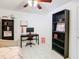 View of the bedroom with black bookshelves, desk, ceiling fan, and trundle daybed providing comfort and functionality at 2400 Feather Sound Dr # 635, Clearwater, FL 33762
