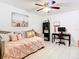 Bright bedroom with a trundle daybed, decorative pillows, desk and ceiling fan, offering versatile living space at 2400 Feather Sound Dr # 635, Clearwater, FL 33762
