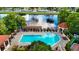 Overhead view of the community pool, featuring a trellis, comfortable seating, and a tranquil lake with a fountain at 2400 Feather Sound Dr # 635, Clearwater, FL 33762