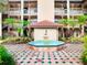 Exterior of a building with a fountain, red tiled roof, and well maintained courtyard at 2400 Feather Sound Dr # 635, Clearwater, FL 33762