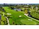 Picturesque view of the golf course featuring lush green fairways, a sand trap, and a tranquil lake at 2400 Feather Sound Dr # 635, Clearwater, FL 33762