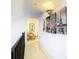 Bright hallway with art-adorned walls, leading to a cozy nook with a comfortable chair and serene atmosphere at 2400 Feather Sound Dr # 635, Clearwater, FL 33762
