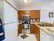Kitchen with wood cabinets, stainless steel appliances, and tile countertops at 2400 Feather Sound Dr # 635, Clearwater, FL 33762