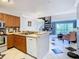 Bright kitchen featuring wood cabinets, stainless steel appliances, and an open layout connecting to the living area at 2400 Feather Sound Dr # 635, Clearwater, FL 33762