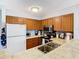 Kitchen featuring wood cabinets, modern appliances, and tile countertops at 2400 Feather Sound Dr # 635, Clearwater, FL 33762