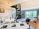 Living room with spiral staircase, elegant chandelier, and sliding glass doors to balcony offering great natural light at 2400 Feather Sound Dr # 635, Clearwater, FL 33762