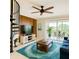 Living room featuring a spiral staircase, balcony, and a bright blue rug at 2400 Feather Sound Dr # 635, Clearwater, FL 33762