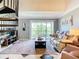 Bright living room with spiral staircase, balcony access, and tile flooring at 2400 Feather Sound Dr # 635, Clearwater, FL 33762