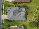 An overhead view of a backyard featuring a large pool, landscaped lawn and a white picket fence at 26701 Winged Elm Dr, Wesley Chapel, FL 33544