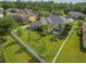 Aerial view of a home showcasing a large, fenced backyard, mature landscaping, screened-in patio, and outdoor seating area at 26701 Winged Elm Dr, Wesley Chapel, FL 33544