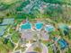 Aerial view of community amenities including swimming pools, tennis courts, and playground at 26701 Winged Elm Dr, Wesley Chapel, FL 33544