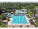Aerial view of a resort-style pool with water slides, lap lanes, and shaded lounge areas at 26701 Winged Elm Dr, Wesley Chapel, FL 33544