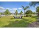 Spacious, fenced backyard with a well-maintained lawn and a cozy fire pit area at 26701 Winged Elm Dr, Wesley Chapel, FL 33544