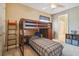 Cozy bedroom with a wooden bunk bed, ladder, and built-in shelves, perfect for a or guest at 26701 Winged Elm Dr, Wesley Chapel, FL 33544