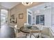 Cozy breakfast nook features a round table with white chairs and access to the lanai with a view of the pool at 26701 Winged Elm Dr, Wesley Chapel, FL 33544