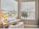 Bright home desk area with natural lighting and view overlooking the pool and backyard at 26701 Winged Elm Dr, Wesley Chapel, FL 33544