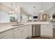 Modern kitchen with stainless steel appliances, marble countertops, and white cabinets at 26701 Winged Elm Dr, Wesley Chapel, FL 33544