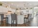 Well-equipped kitchen with a large island with bar stools and a stainless steel refrigerator at 26701 Winged Elm Dr, Wesley Chapel, FL 33544