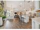 Bright, open floor plan with modern kitchen featuring granite countertops, and pendant lighting at 26701 Winged Elm Dr, Wesley Chapel, FL 33544