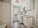 Well-organized laundry room with modern washer and dryer, sink, storage cabinets, and charming decorative touches at 26701 Winged Elm Dr, Wesley Chapel, FL 33544