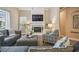Comfortable living room with fireplace, large windows, hardwood floors and modern furnishings at 26701 Winged Elm Dr, Wesley Chapel, FL 33544