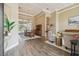 Spacious living room boasts coffered ceilings, hardwood floors, and views of the pool area at 26701 Winged Elm Dr, Wesley Chapel, FL 33544