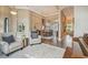 Open-concept living area featuring hardwood floors, a coffered ceiling, and elegant furnishings at 26701 Winged Elm Dr, Wesley Chapel, FL 33544