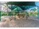 Well-maintained playground with covered play structures, swings, and a wood chip ground cover at 26701 Winged Elm Dr, Wesley Chapel, FL 33544