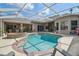A screened in pool and spa with outdoor seating and covered patio area at 26701 Winged Elm Dr, Wesley Chapel, FL 33544