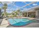 Enjoy swimming in this screened in pool and spa surrounded by a patio and lush landscaping at 26701 Winged Elm Dr, Wesley Chapel, FL 33544