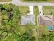 Aerial view showcasing the home's roof, driveway, and surrounding lush landscaping at 2675 Cherokee St, North Port, FL 34286