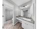 Well-lit bathroom featuring a sleek vanity and a glass-enclosed shower at 2675 Cherokee St, North Port, FL 34286