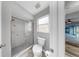 Modern bathroom features a glass-enclosed shower, toilet, and wood-look flooring at 2675 Cherokee St, North Port, FL 34286