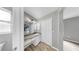 Bright bathroom featuring a granite countertop, well-lit vanity, white cabinets, and a closet at 2675 Cherokee St, North Port, FL 34286