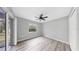 Cozy bedroom features new wood-look floors, a ceiling fan, and sliding doors to the outside at 2675 Cherokee St, North Port, FL 34286