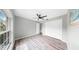 Spacious bedroom featuring wood-look floors, ceiling fan, and a connected bathroom at 2675 Cherokee St, North Port, FL 34286