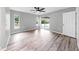 Light bedroom showcases wood-look floors, ceiling fan, and sliders to lanai at 2675 Cherokee St, North Port, FL 34286