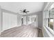 Spacious bedroom featuring new wood-look flooring, a ceiling fan, and a sliding glass door at 2675 Cherokee St, North Port, FL 34286