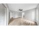 Bright bedroom featuring wood-look floors, a ceiling fan, and natural light from sliding doors at 2675 Cherokee St, North Port, FL 34286