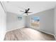 Light-filled bedroom boasts modern ceiling fan, wood-look floors and a large window with a view at 2675 Cherokee St, North Port, FL 34286